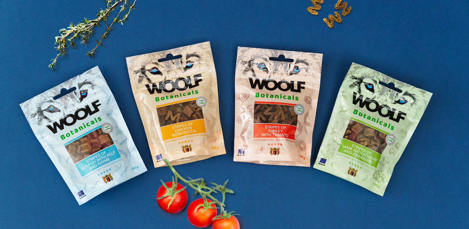 Produktová řada odměny pro psy Woolf Botanicals. Obalový design na sáček doypack pro značku Woolf na pozadí s čerstvou zeleninou.